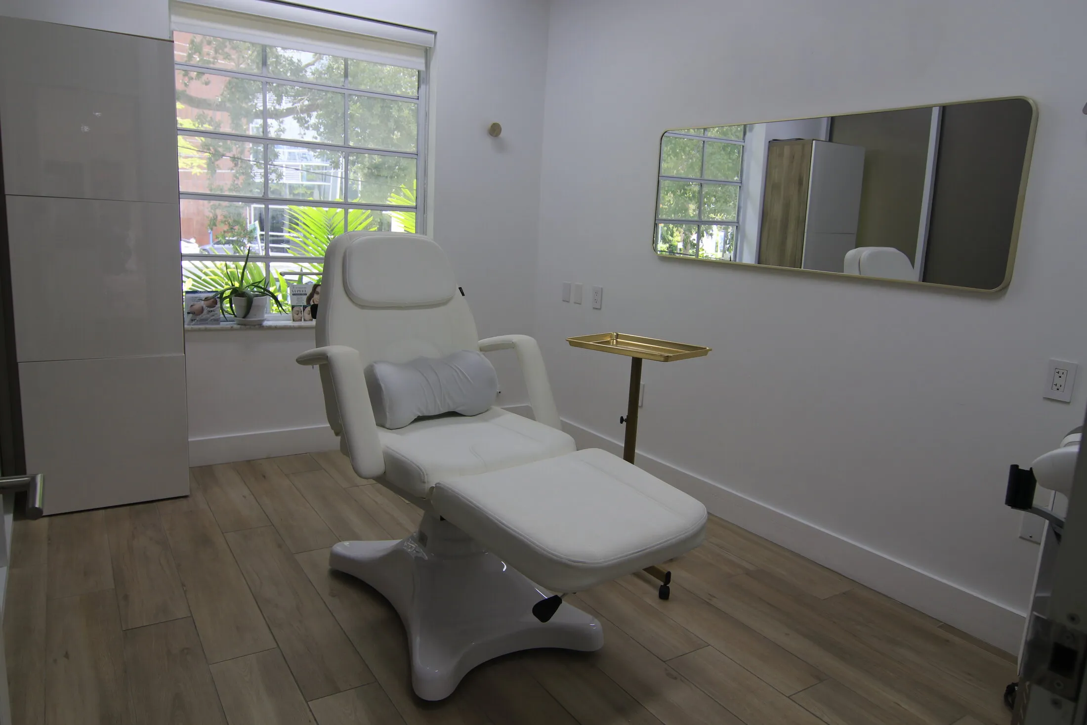 Facial and injectables treatment room with a powered chair and window at Miami Skin Spa in Brickell
